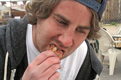 Sam Grossman takes a bite of a Rocky Mountain Oyster at the second annual Beer n Balls Festival at the Four Deuces Saloon and Grill in Tombston, Ari
