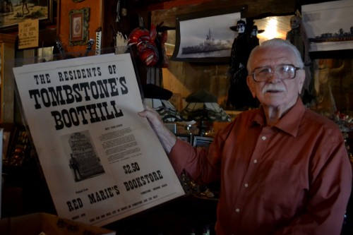 Ben T. Traywick holds up a paper from his collection of historical archives at Red Marie’s Bookstore.