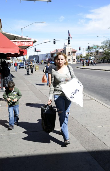 Keyla Riesgo (right) walks with her son, Andres Beltran (left), towards the border crossing into Mexico in Nogales, Ariz.  Riesgo has bought groceries and new front bumper for the family car.  Estimates are more than 60 percent of Nogales' sales tax comes from people who live in Mexico, according to the Arizona-Mexico Committee website.