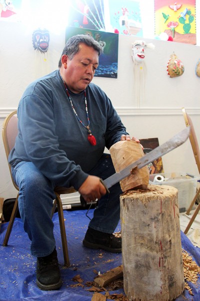 Louis David Valenzuela carves a Pascola mask out of cottonwood at the American Indian Gem Show Exhibition on Sunday, February 9, 2014. (Photo by Ashlie Stewart)