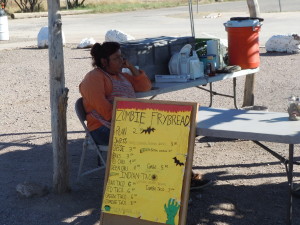 Jennifer Juan sits behind her fry bread stand in front of the San Xavier del Bac Mission. Photo by Chris Real/Arizona Sonora News Service