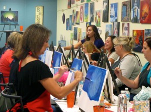 Guests begin to paint a scenic landscape at Tucson's paint and wine bar Brush N Bottle. 