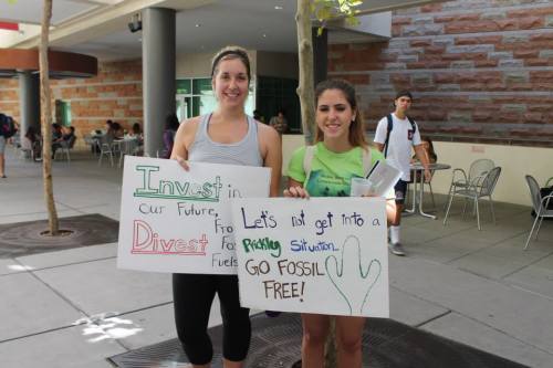 Students on the UA campus hold signs to show support for the campaign. Photo courtesy of Divest UA.