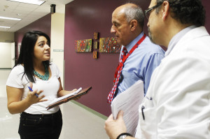 Journalism student Stefani Quihuis (left), interviews Dr. Richard Carmona (center), 17th surgeon general of the United States, and Dr. Andreas Theodorou, chief medical officer of the University of Arizona Health Network, (right), about the flu pandemic exercise held Oct. 31 at the Arizona Health Sciences Center campus. The exercise was held to prepare students in nursing, medicine, public health, social work, law and journalism for a pandemic in case they ever experience one in their careers. It was the first time students from the School of Journalism participated in the annual exercise. Photo by Briana Sanchez.