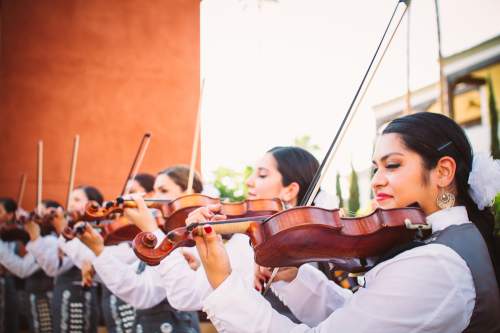 Violinists from the all female group Mariachi Pasion get ready to strum away at a local event. Photo courtesy of www.mariachipasion.com