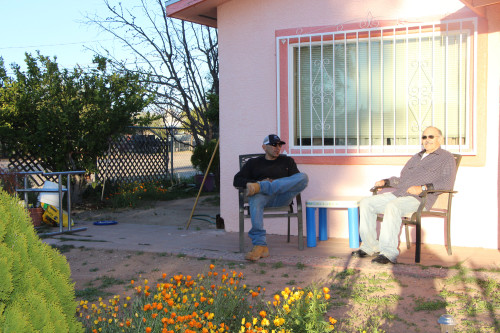 J.J. Hernández and his father sit out front of their home in southern Tucson and enjoy the cool February weather. (Photo by Michaela Kane/ Arizona Sonora News)