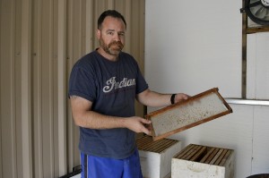 Anthony Tubbiolo, owner of Holly's Little Farm has operated his business for the past 5 years. Tubbiolo demonstrates how to use a langstroth hive. (Photo by Stephanie Romero/ Arizona Sonora News).