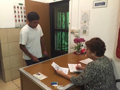 Hector Calderon-Rodriguez, a Oaxaca-native, awaits the registration process that is administered by Gilda Esquer, co-founder of the Albergue para Migrantes San Juan Bosco, a migrant center located blocks away from the Nogales, Sonora/Nogales, Arizona border checkpoint.  (Photo by Crystal Bedoya) 