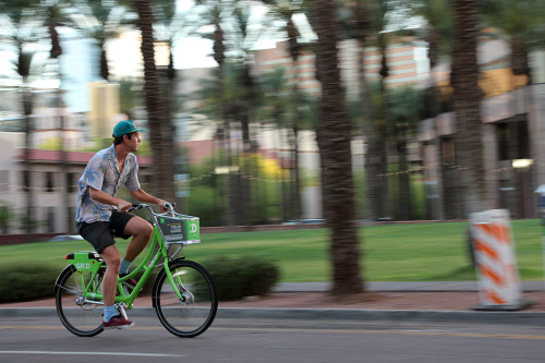 Owen Blacutt rides a share bike through downtown Phoenix, Arizona. Photo by: Ryan Foley/Arizona Sonora News