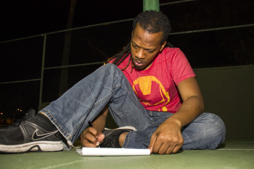 Christopher Owens, professional poet, writes a new poem in his apartment complex in Phoenix, Ariz. on Tuesday, May 5, 2015. One line from his new poem is, Youre not promised tomorrow/ but instead of trying to slam dunk/ most of us would rather fade away. Photo by Rebecca Marie Sasnett / Arizona Sonora News Service