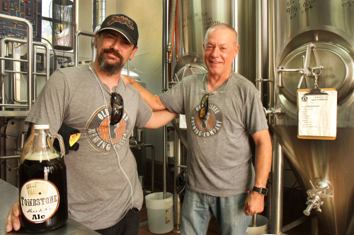 Inside their brew house owner/brew master Victor Winquist (right) stands with Buster Garvin, marketer and distributer of Old Bisbee Brewing Company. Photo by Emily Lai/Arizona Sonora News Service.