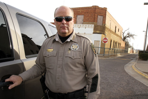 Cochise County Sheriff Mark Dannels stands outside his vehicle in Naco, Arizona - a port of entry to Mexico. Photo by Emily Lai/Arizona Sonora News. 