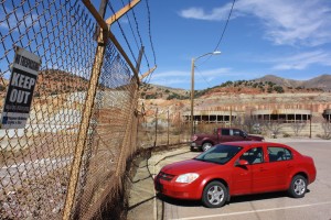 A fence with barbed wire surrounds the open-pit mine in Bisbee, Ariz. (Photograph by Devon Confrey)