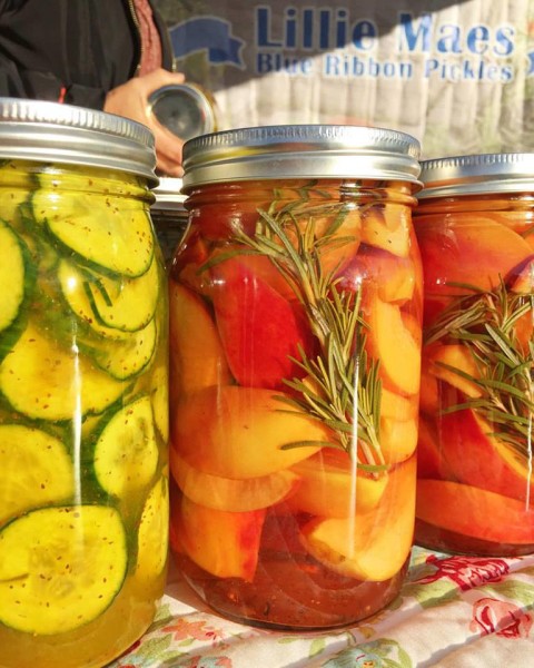Jars of Dawn Petersen's pickles and spiced pickled peaches are sold at the Lillie Mae's Blue Ribbon Pickled Garden booth at the Uptown farmers' market in Phoenix, Arizona on Wednesday, Jan. 6. Photo by Uptown farmer's market.
