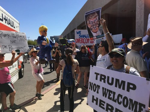Protestors stand outside Donald Trumps rally on March 19, 2016.