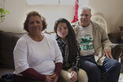 Natalie Guerrero Hernández  (center) with her parents in their home in Nogales, Sonora.