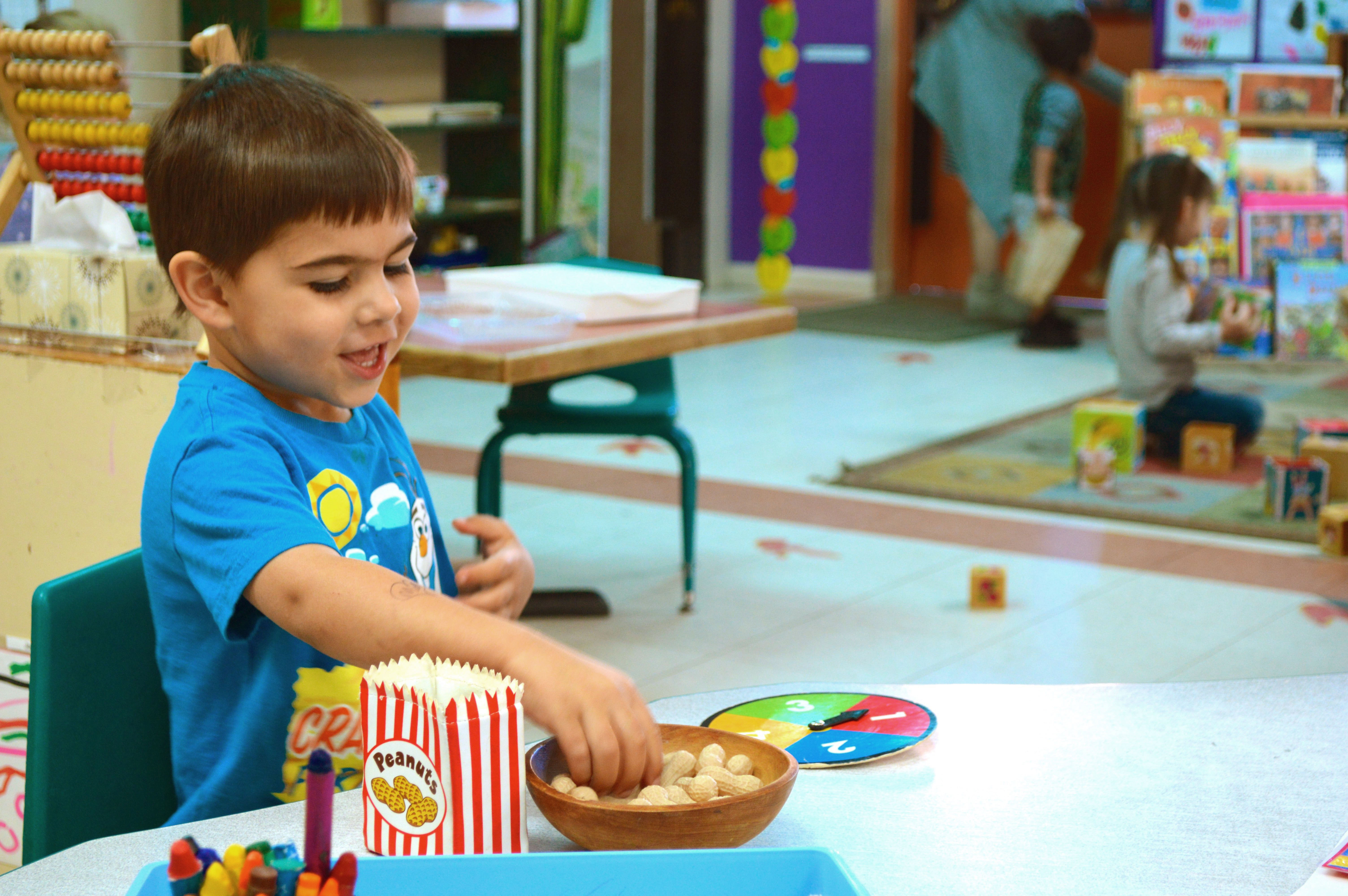 Diego plays with peanuts at the Sandbox Early Childhood Center. Photo by Shannon Higgins/Arizona Sonora News