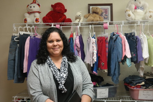 Tina Upshaw, executive director of CareNet Pregnancy Center of Cochise County stands in front of her clinics baby boutique. Parents may exchange mommy money and daddy dollars earned through taking classes for clothes, toys, books and more.  (Photo by: David Mariotte/ Tombstone Epitaph)