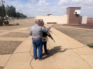 Larry Lykins, manager at Tucson Trap and Skeet showing Alexa Portillo where the plates in trap shooting move. Photo by Alexa Portillo/ Arizona Sonora News Service