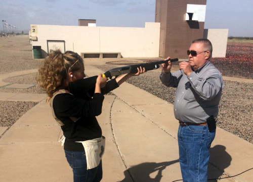 Larry Lykins showing Alexa Portillo where her dominate eye should be placed on the shotgun. Photo by Alexa Portillo/ Arizona Sonora News Service