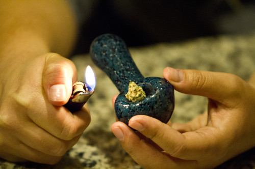Person lights a marijuana filled pipe. (Photo by: Jordan Glenn/ El Independiente)