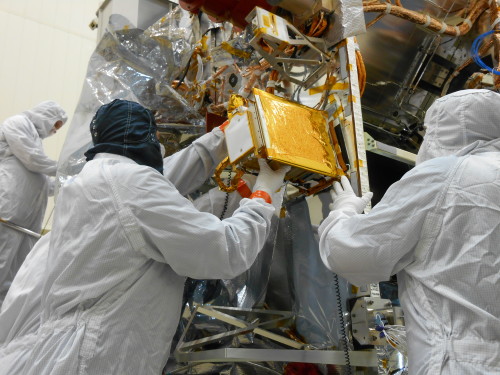 Engineers install the REXIS instrument onto the OSIRIS-REx spacecraft in a Lockheed Martin clean room in Denver, Colorado. Photo courtesy of Lockheed Martin