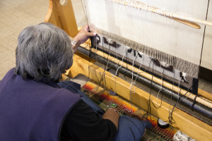 Master Weaver Ruby Hubbard works on a new rug on the upright floor loom at the Hubbell Trading Post National Site visitor’s center. She said she can complete two inches during a day’s shift. This rug will be in the Two Gray Hills style, distinguished by its three colors: brown, gray and white.