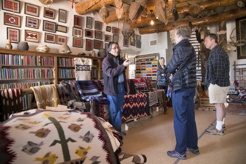 Edison Eskeets talks to tourists in the rug room at Hubbell Trading Post National Site in Ganado. Eskeets is the trader at Hubbell, where trading handmade goods is still a viable living.