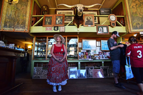 Patty Feather gives an abridged tour of the entry room in the Bird Cage Theatre to visitors in Tombstone, Ariz. on Sunday, Sept. 18, 2016. Feather and her husband moved from Pennsylvania to Tombstone about two and a half years ago in search of warmer and drier weather. Feathers husband, Jack, owns and operates Tombstone Hearse, a business that makes specialty motorcycle trikes descibed as a Victorian-era horse drawn hearse, substituting the horses with motorcycle power. (Photo by Rebecca Noble / Arizona Sonora News Service)