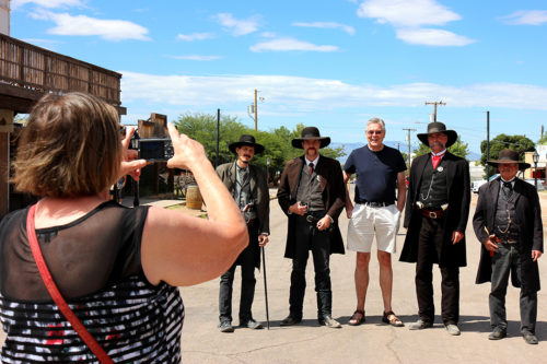 A German tourist takes a picture of her husband while he poses with the O.K. Corral reenactors on Allen Street in Tombstone, Ariz. on Sunday, Sept. 25, 2016. The actors were advertising for the 12 oclock reenactment of the infamous shootout between Virgil Earp, Morgan Earp, Wyatt Earp and Doc Holliday against the McLaurys and the Clantons that took place on Wednesday, Oct. 26, 1881. (Photo by Julianne Stanford / Arizona Sonora News Service)