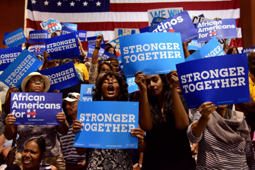 Derosette McClain (center) cheers before First Lady Michelle Obama's speech at the Phoenix Convention Center in Phoenix, Ariz. on Thursday, Oct. 20, 2016. "Hillary has my full support," said McClain. "The support, the encouragement she gives to women - it just doesn't get any better." (Photo by Rebecca Noble / Arizona Sonora News)