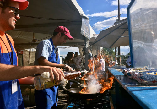 A young man prepares Saganaki at Tucsons 40th annual Greek festival. This dish is a traditional pan-seared cheese dish, a popular appetizer in Greece. (Photo by Allie Goodman / Arizona Sonora News)