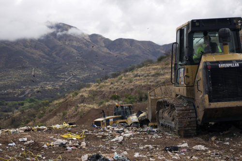 Workers move trash and food waste at the Rio Rico landfill in Nogales, Arizona on March 7, 2016. (Photo by Tobey Schmidt / Arizona Sonora News) 
