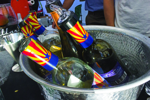 Bottles of Willcox Arizona wine sit on display at the Cellar 433 booth at the Fall 2016 Willcox Wine Country Festival in Willcox, Arizona on Sunday, Oct. 16, 2016.  John McLoughlin is the owner of Cellar 433 and was the driving force behind the Willcox application for American Viticultural Area designation. (Photo by Natalia Navarro / Arizona Sonora News)