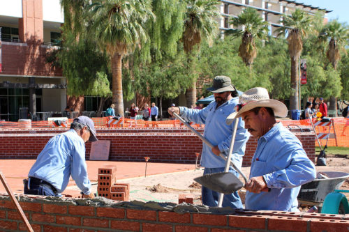Chuy Gutierrez, Edward Pollock, and their coworkers construct the U.S.S. Arizona Memorial on the University of Arizona campus in Tucson, Ariz. on Monday, Oct. 10, 2016. (Photo by Amanda Sladek / Arizona Sonora News)