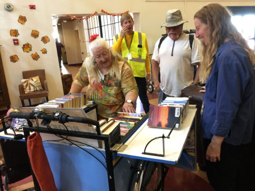 Karen Greene, right, helps interested readers find material from the Bookbike at the Armory Park Senior Center on Wednesday, Nov. 23, 2016. The Bookbike is run by the Pima County Library and brings free books to locations and organizations around the city.