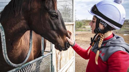 Amelia Hauschild, age 16, greets her horse before her first professional race.