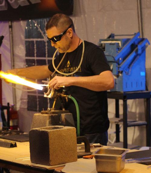 John Lynch works on his glass art piece at the Flame-Off competition on Feb. 3 in Tucson, Arizona. (Photo by Ross Olson)