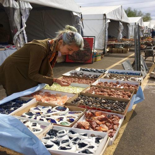 Tucson native Eleana Kanna looks at minerals from Morocco during the Main Ave Fossil & Mineral Show (Photo by: Paige Facchino/Arizona Sonora)