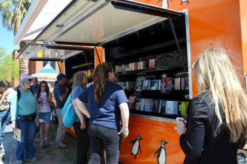 Festivalgoers browse the Penguin Book Trucks selection at the Festival of Books on the UA Mall on Saturday, March 15, 2014. The Festival of Books will run on the UA Mall from Saturday to Sunday and offers a wide variety of interesting activities and events (Photo by: Rebecca Noble / The Daily Wildcat)