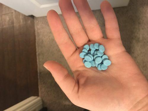 Several generic Adderall pills in the hand of University of Arizona student Lilly. (Arizona Sonora News Service)