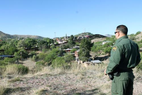 Agent Daniel Hernandez of the Border Patrol looks out over the U.S. - Mexico border in Nogales, AZ. (Photo by: Erik Kolsrud/Arizona Sonora News)