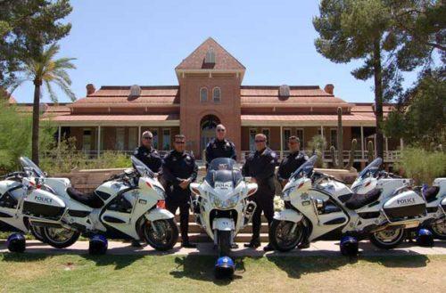 Members from UAPD pose in front of Old Main, ready to improve campus safety. 