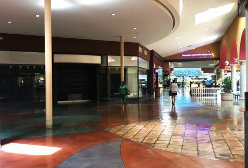 The desolate mall has dozens of dark store fronts in wait for new tenants. 