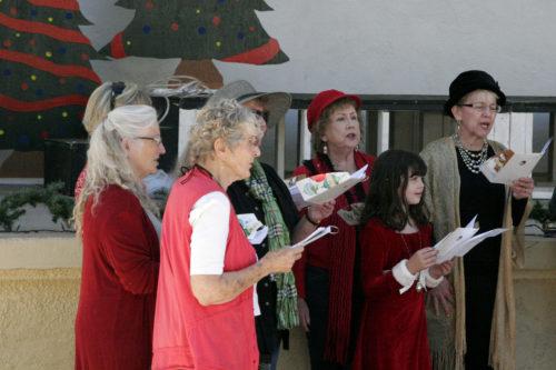 Members of the Bisbee Community Chorus sing Christmas Carols to get the audience in the holiday spirit at the Bisbee Festival of Lights on Nov. 24, 2017, in Bisbee Ariz. The Chorus carols at four different events around Bisbee throughout December. (Photographed by Leah Gilchrist/ Arizona Sonora News)
