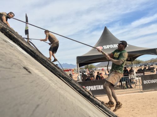 Spartan Race participant climbing up an obstacle during the Spartan Race in Phoenix, Ariz. on Feb. 10, 2018. (Photograph by: Alex DeMarzo/Arizona Sonora News)