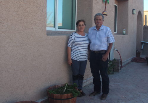 Juana and Silvano stand outside their home. Photo by Noemi Salazar Mata/ASNS.