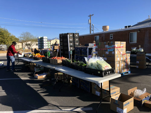Volunteers set up a farmers market on Saturday, January 27, 2018 in Tucson, Ariz. (Photograph by: Sara Harelson)