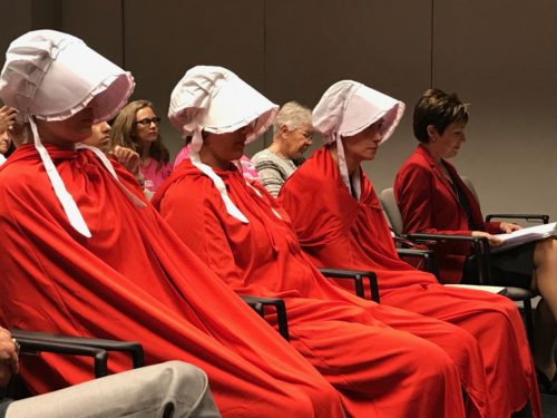 Protesters dressed as handmaids from Margaret Atwoods The Handmaids Tale sit in protest during debate on an abortion reporting bill. (Photo by: Erik Kolsrud/Arizona Sonora News)