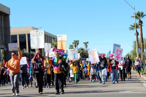 People walk the streets in Phoenix during the Womens March at the State Capitol Sunday, Jan. 21 2018.